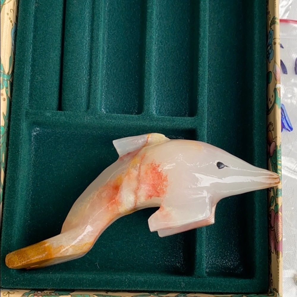 Hand carved stone dolphin with black eyes